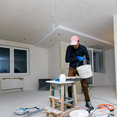 Team member painting inside the home