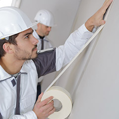 Men prepping walls for painting