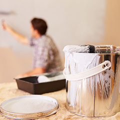 Person painting interior wall