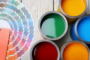 different paint colors and swatches sitting on a floor