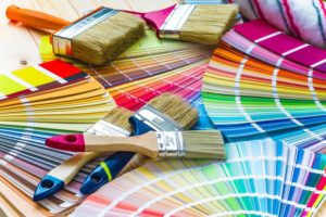 a pile of paint swatches and paint brushes 