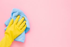 person cleaning the walls in their home