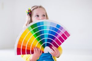 kid with color swatches 