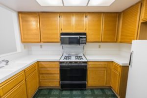 outdated kitchen with yellow cabinets