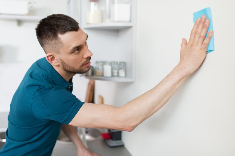 closeup of man cleaning walls