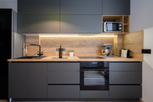a modern kitchen filled with black appliances