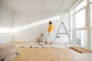 a woman asking her dog to help her paint