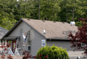 a person painting their home’s exterior